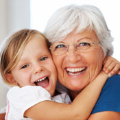 Little girl hugging elderly woman